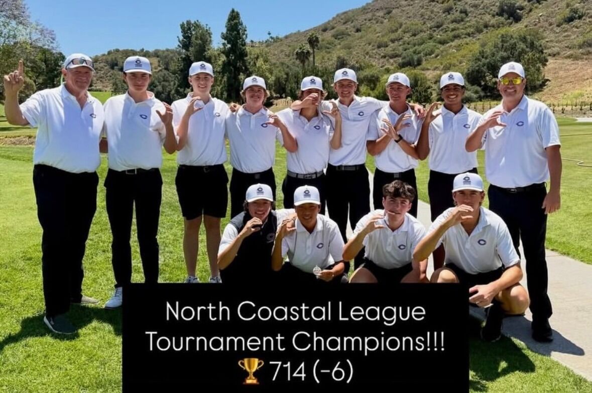 A golf team poses for a photo, celebrating their victory as North Coastal League Tournament Champions.