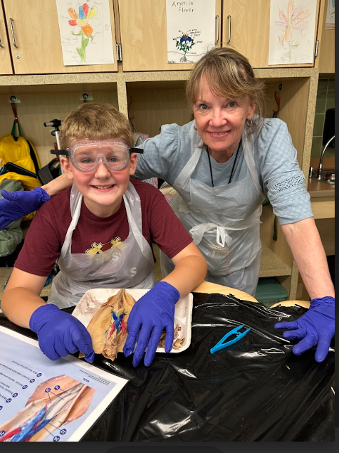 Mrs. Woods doing dissection with a student
