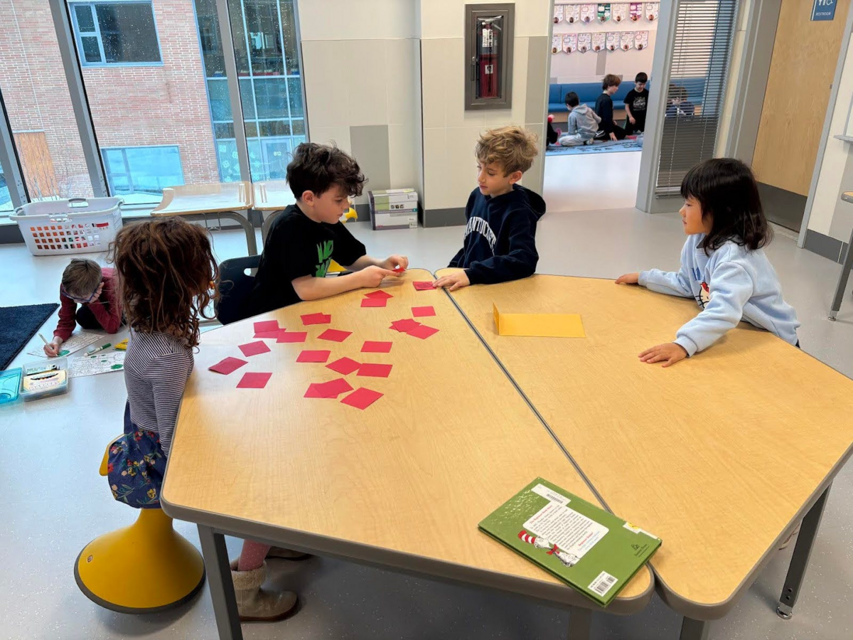 First and third graders play a memory based matching game as part of the Buddies program.