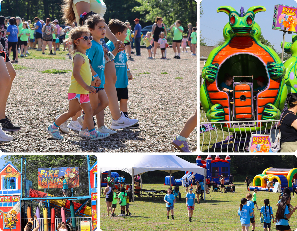 Children walk past a playground area at an outdoor event with inflatable attractions.
