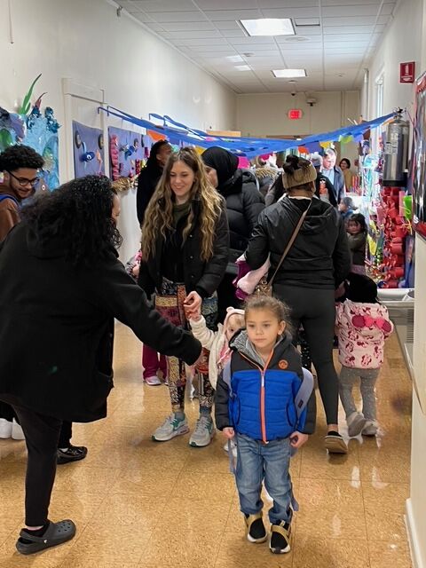 Students and their family parade the hallways of LaMonte Annex exploring the coral reef display all students helped create.