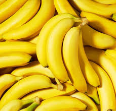 A close-up view of a pile of ripe yellow bananas.