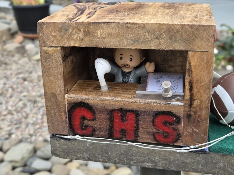 A miniature press box, created by Yvonne, with current stats on the paper on the right.