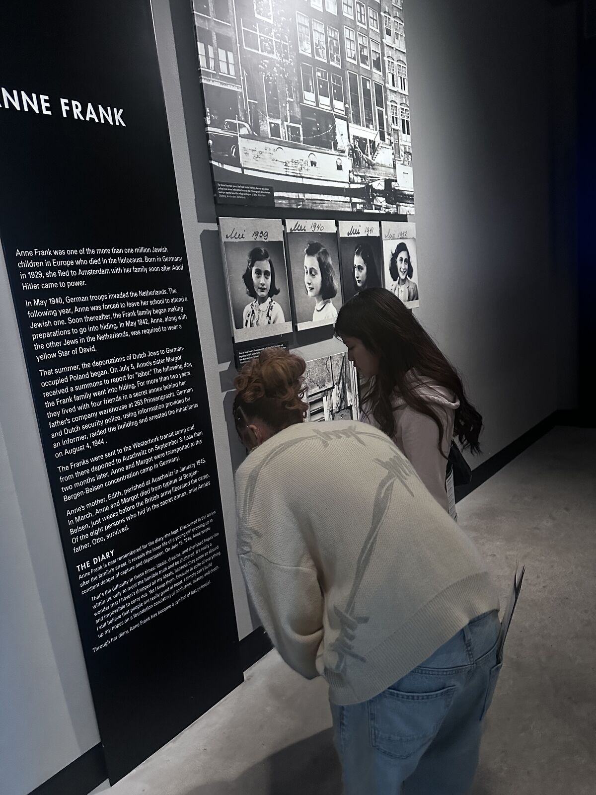 Two students look at a museum display on Anne Frank