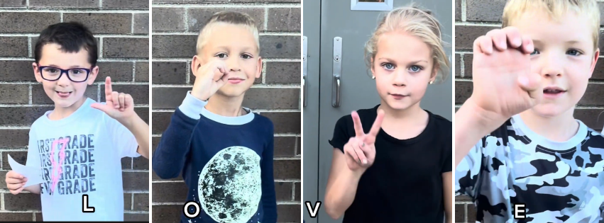 Four children form the letters L, O, V, E with their hands and bodies.