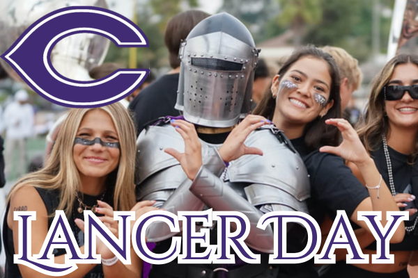 A group of smiling students celebrate Lancer Day, with one person wearing a medieval knight suit of armor.