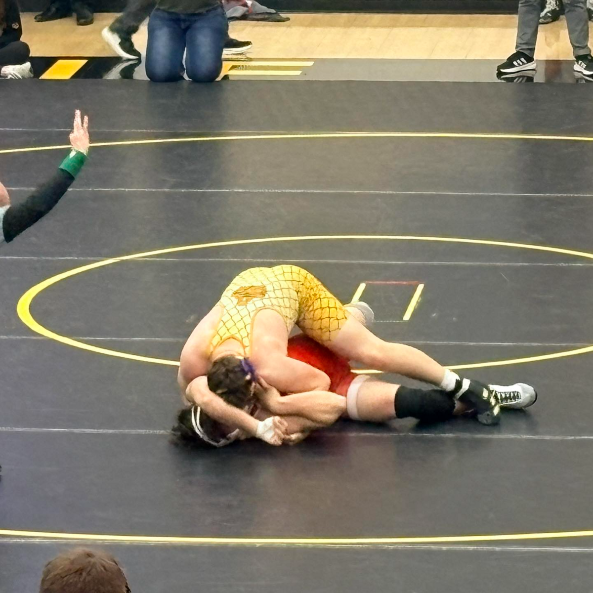 Two wrestlers grapple on the mat during the sectional tournament