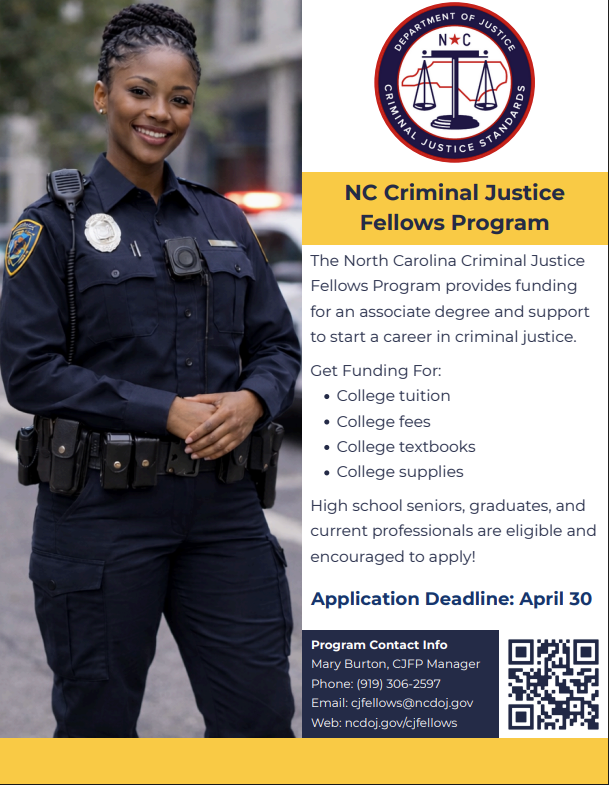 A smiling female police officer in uniform stands in front of a blurred background with flashing lights.
