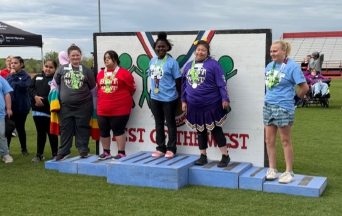 Athletes stand on a blue podium, wearing medals and smiling, with a banner reading 'BEST OF THE WEST' behind them.