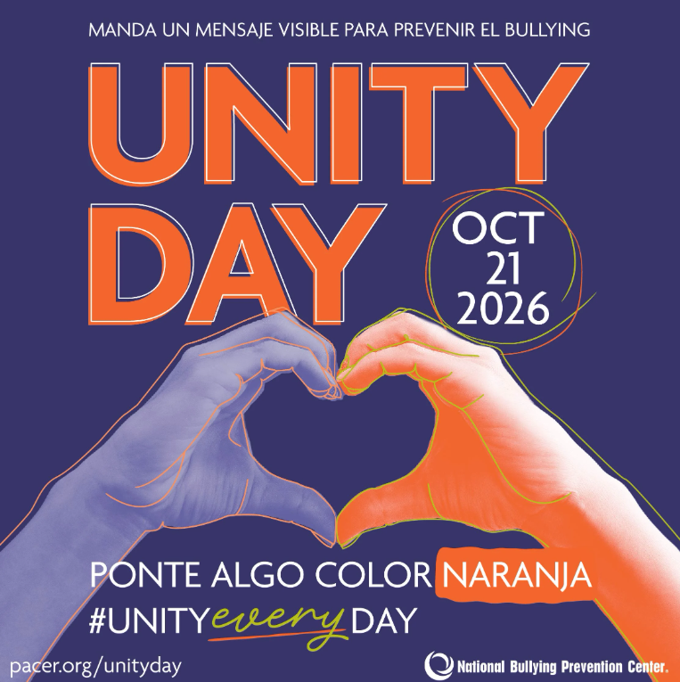 A purple poster for Unity Day on Oct 21, 2026, featuring two hands forming a heart shape and Spanish and English text.