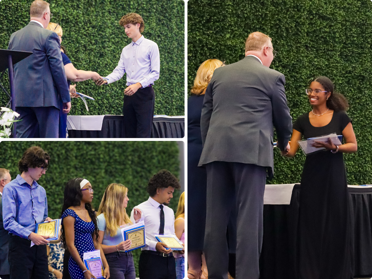 A young man in a light blue shirt receives an award from a woman at a ceremony.