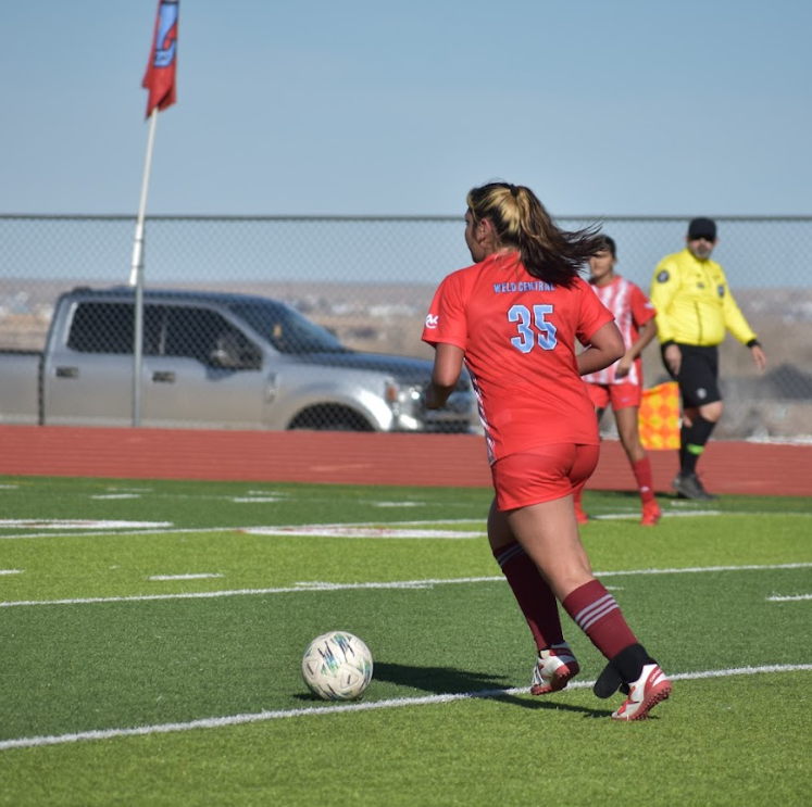 Anamaria takes the ball up the field in a soccer game against Estes Park.