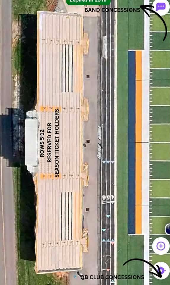 An aerial view of a stadium features a large set of bleachers beside a running track and football field.