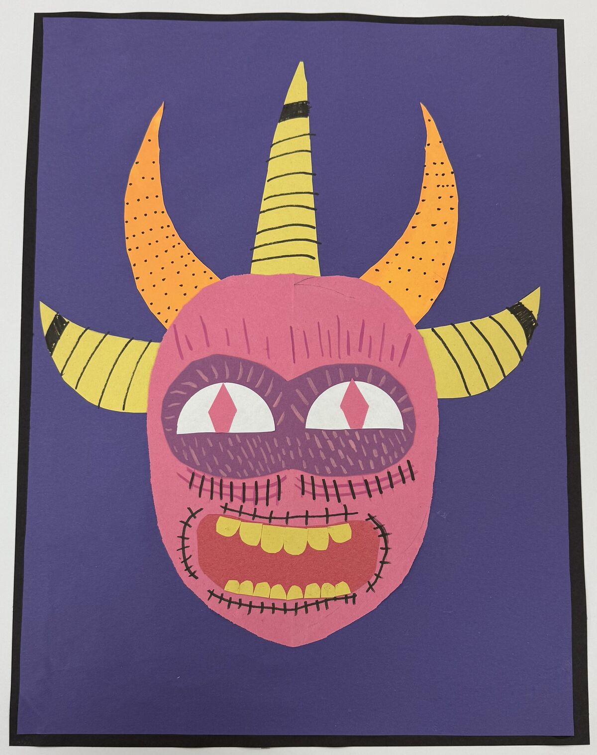 person with a pink face and four yellow horns