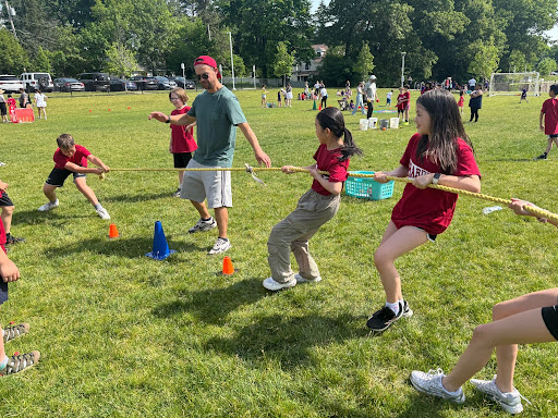 Students play tug of war on the Hardy field.