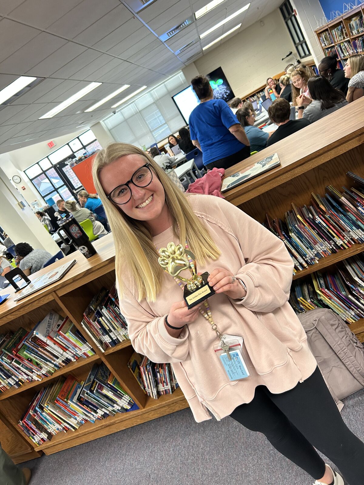 teacher holding a trophy