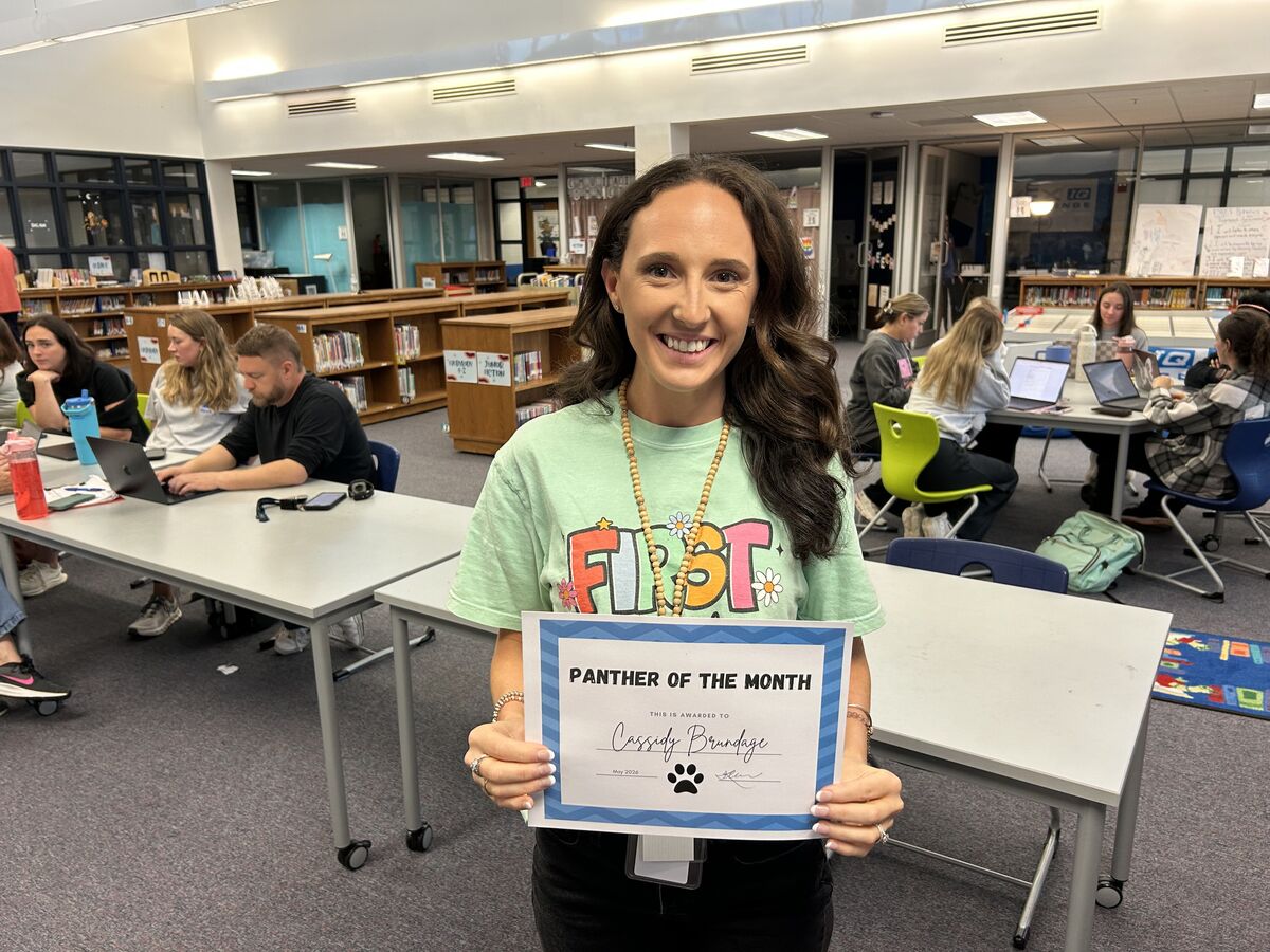 teacher holding a certificate 