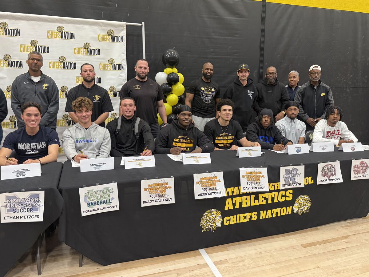 athletes and coaches at signing day
