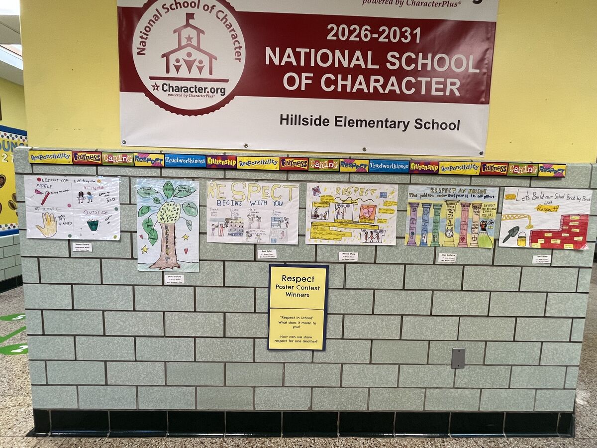 A banner for Hillside Elementary School hangs above a display of student art about respect.
