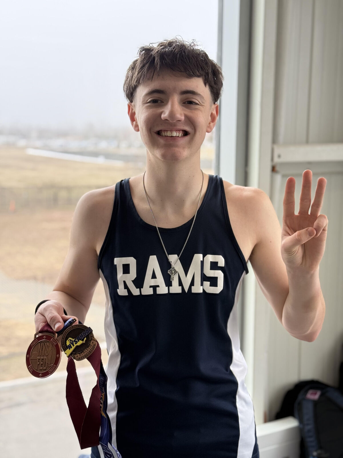 George with his bronze medal at the NYS Indoor Track Championships