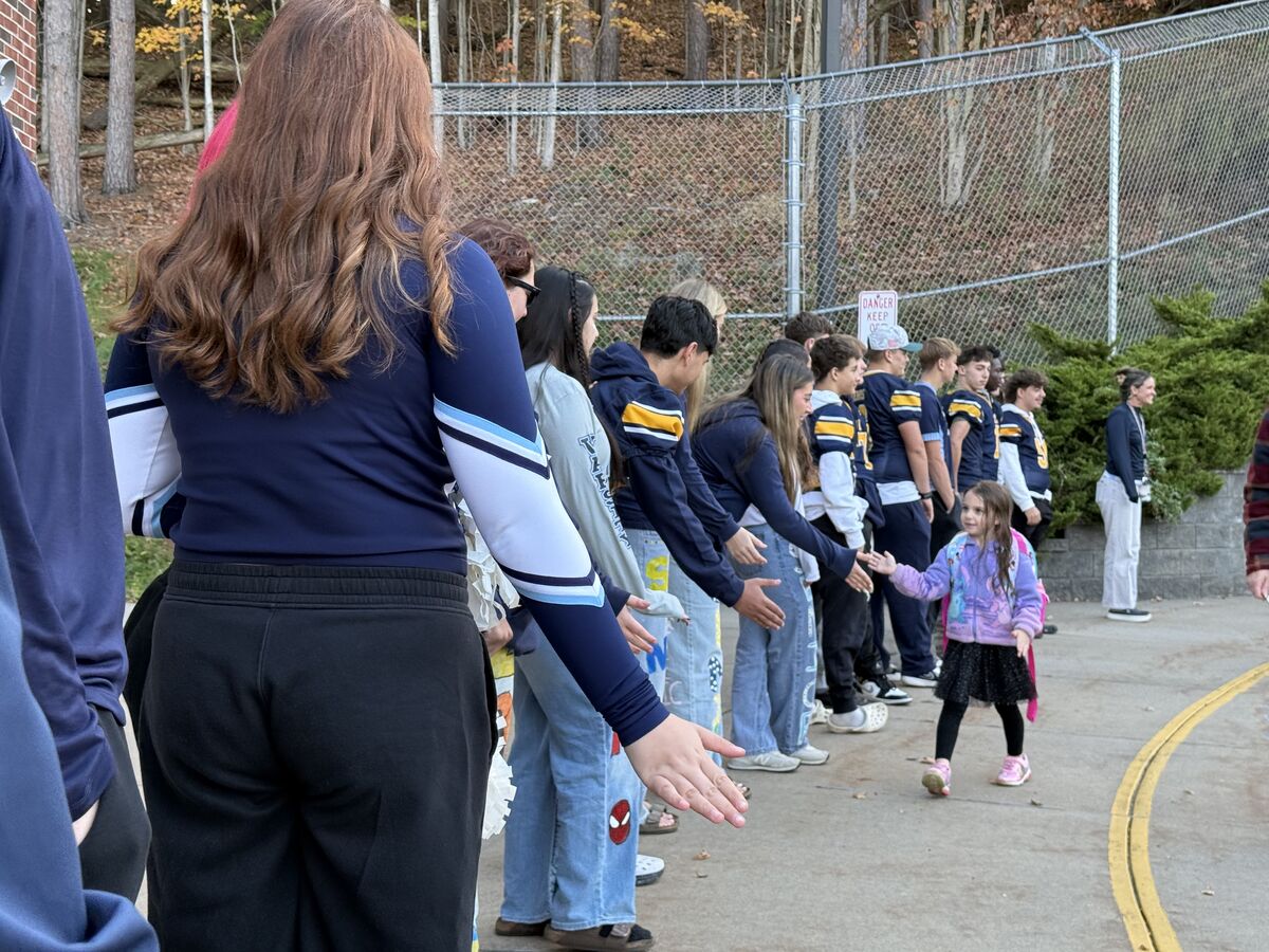 CVA athletes greeting car rider students 10/23/26