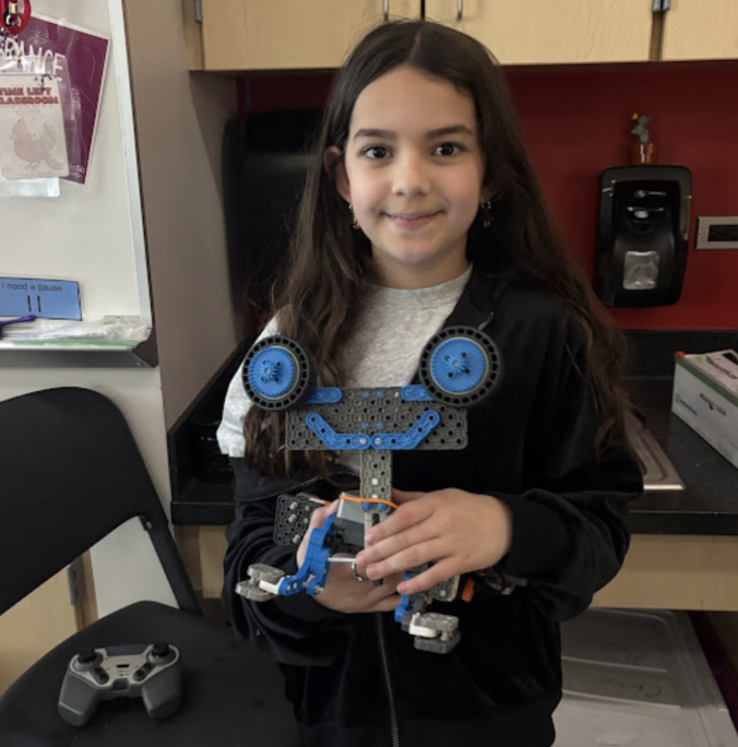 student holding a robot