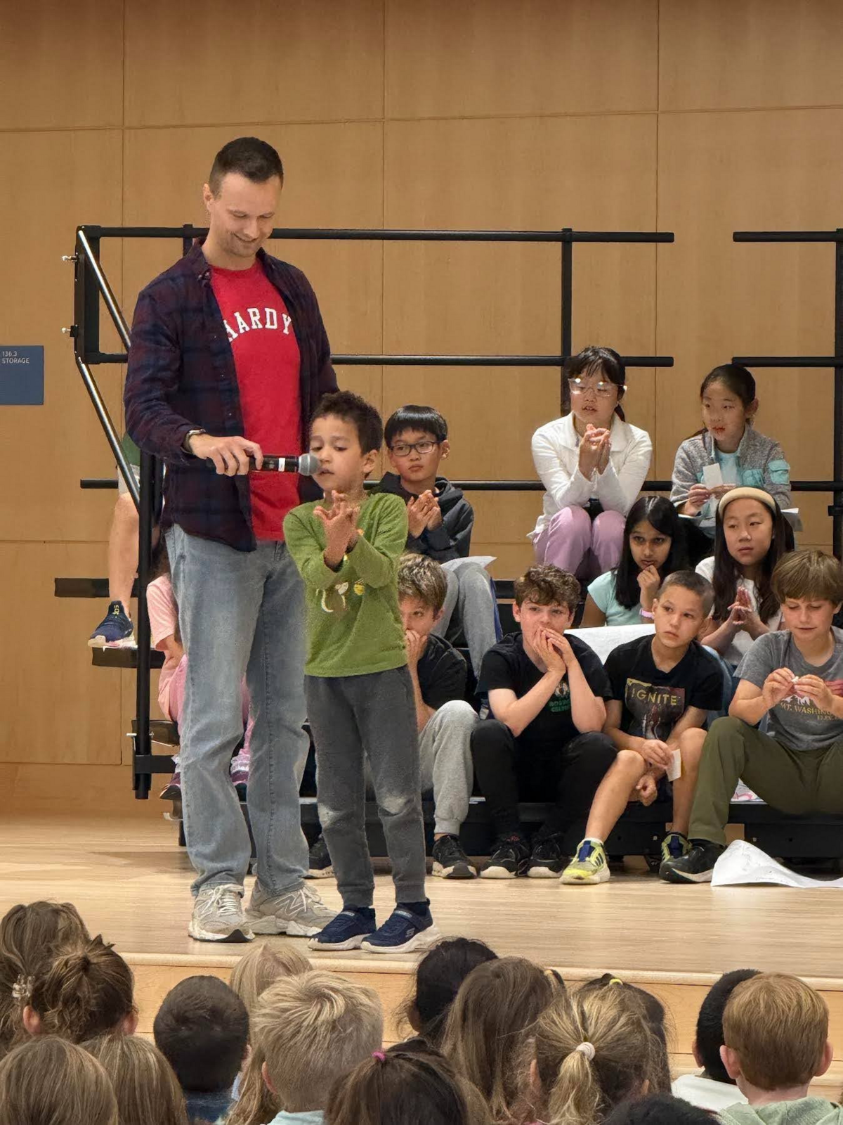 A student makes hand animals in the talent show.
