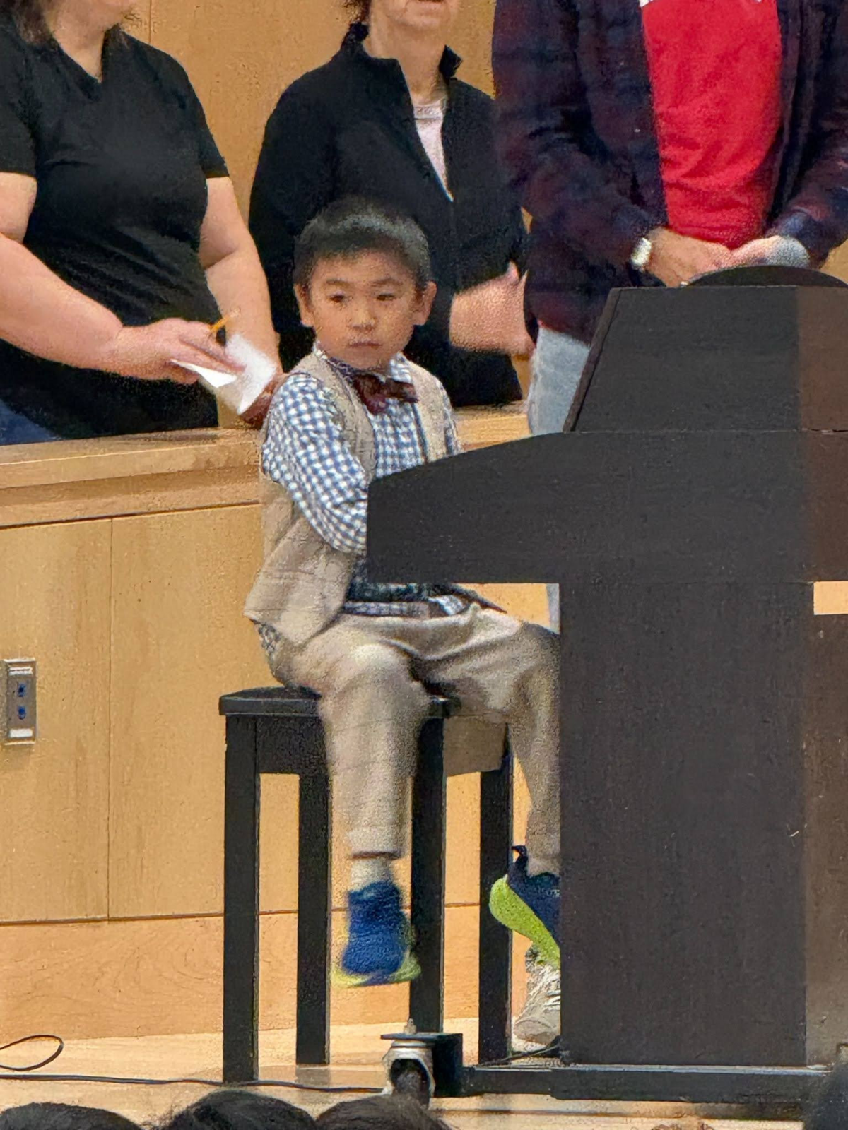 A student plays the piano in the talent show.