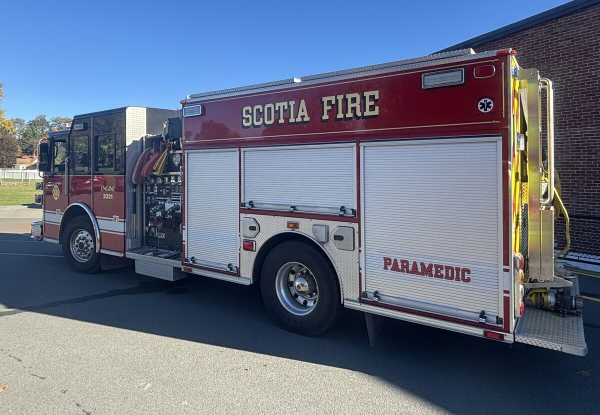 A red and white Scotia Fire and Paramedic engine parked outdoors on an asphalt surface.