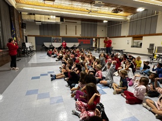 Students sitting and listening to CARE presentation