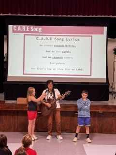 Mrs. Hajj Platt leading students in the FH CARE song.