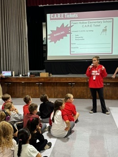 Mrs. Ray explaining CARE program with students sitting in front of her.