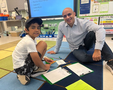 Father and son work on math games.