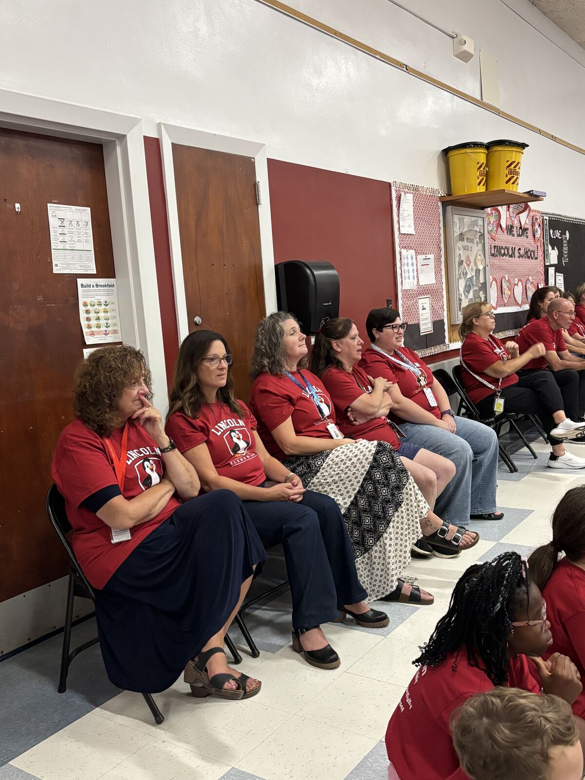 Admin and staff looking on as Mr. Geniti speaks