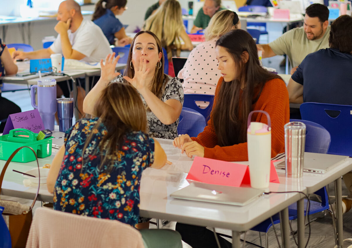 girls at table talking in school