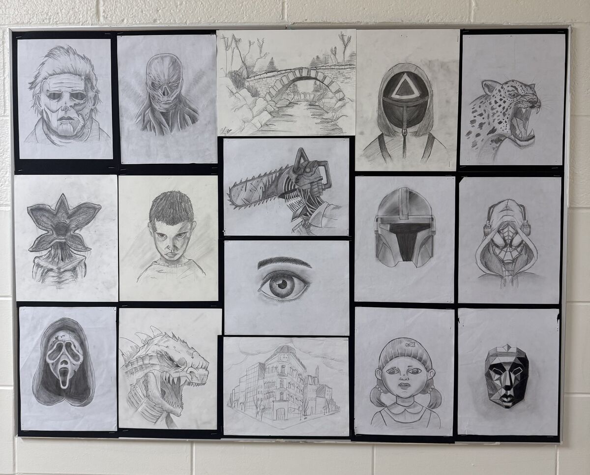A bulletin board displays a collection of pencil sketches featuring various characters, animals, and architectural scenes.