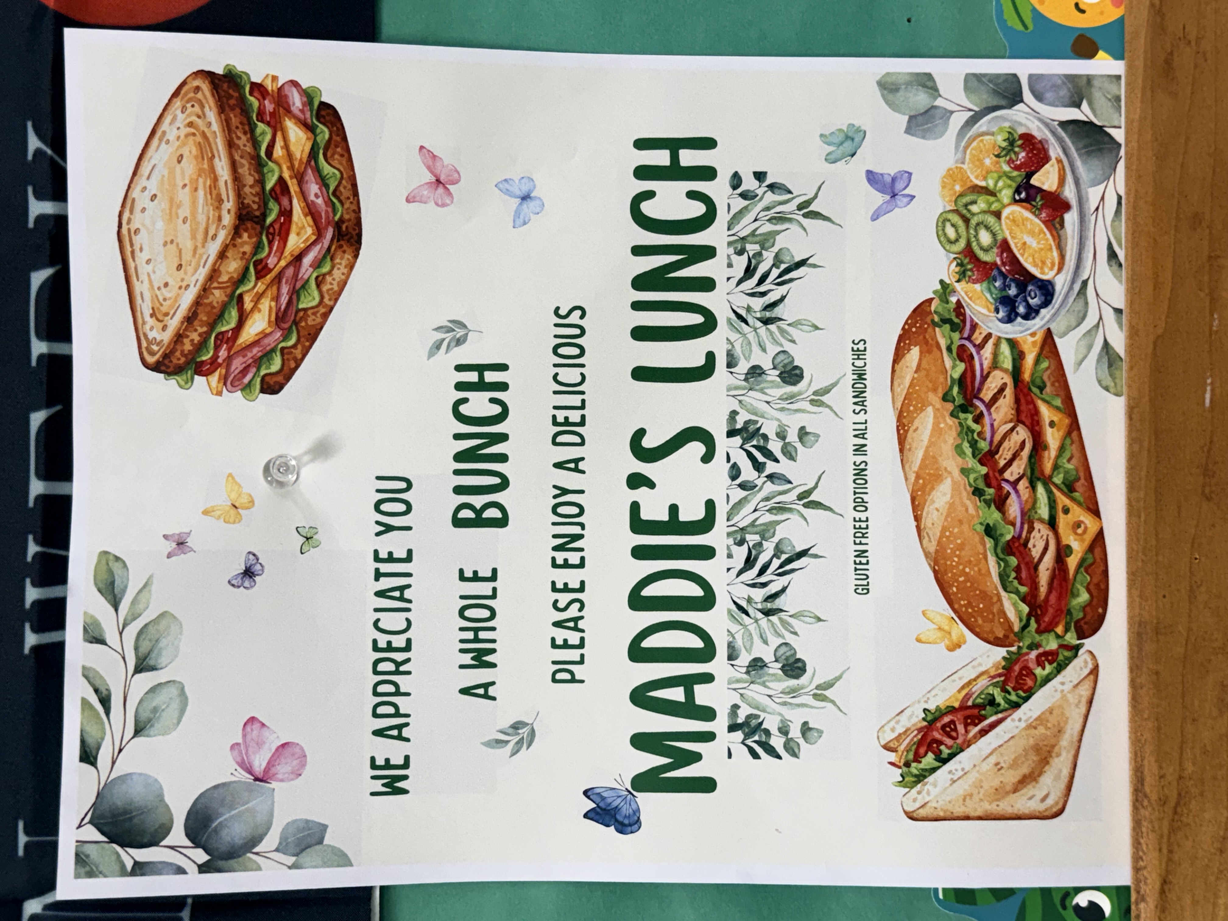 A flyer for 'Maddie's Lunch' features illustrations of sandwiches, fruit, and butterflies.