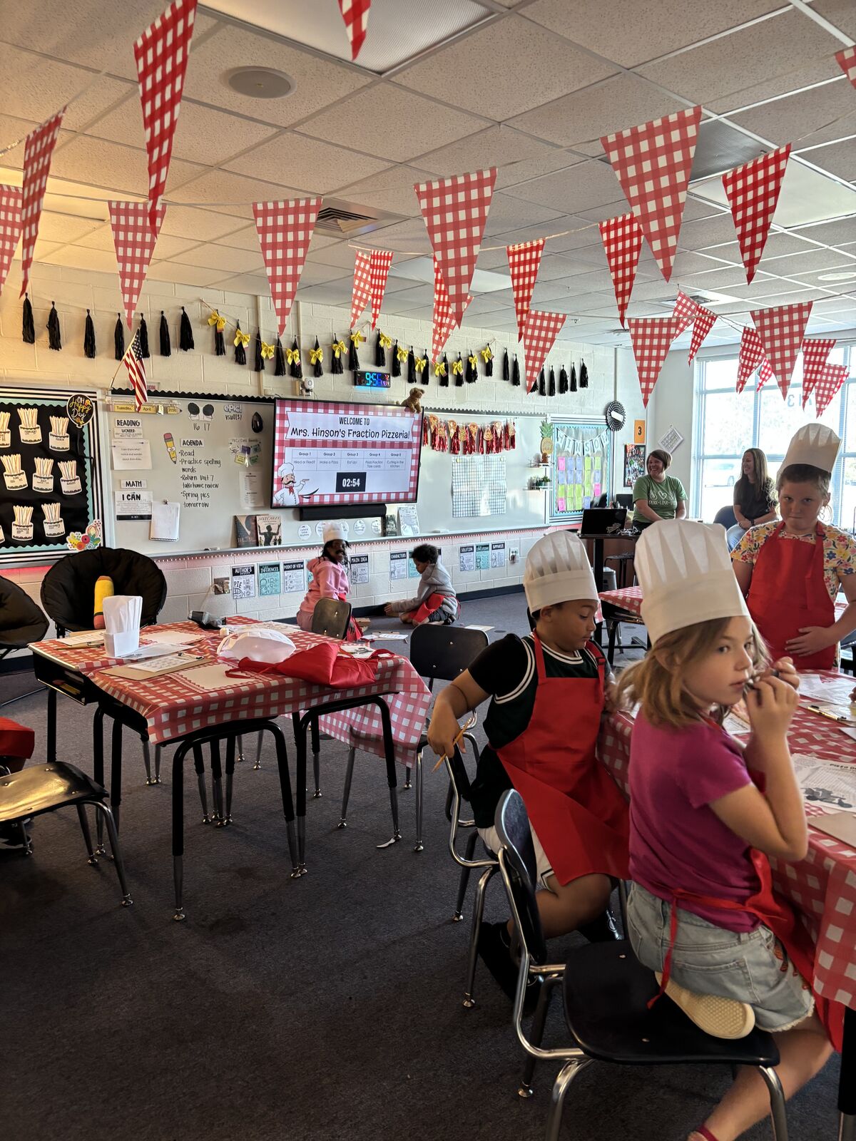 Students creating pizza themed crafts in classroom