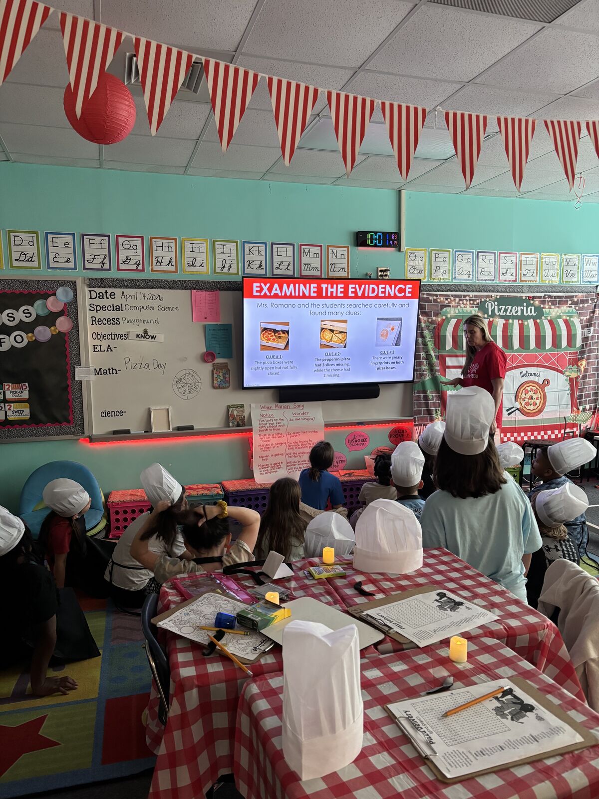 Students creating pizza themed crafts in classroom