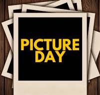 A stack of overlapping polaroid photo frames sits on a wooden background, with the top frame displaying the text "PICTURE DAY" in yellow.