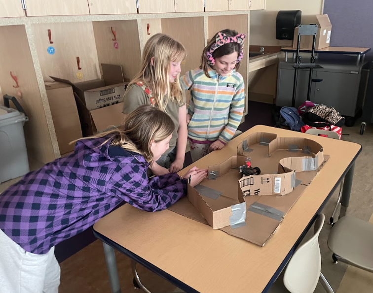 Group of girls using their robot at the STEM program