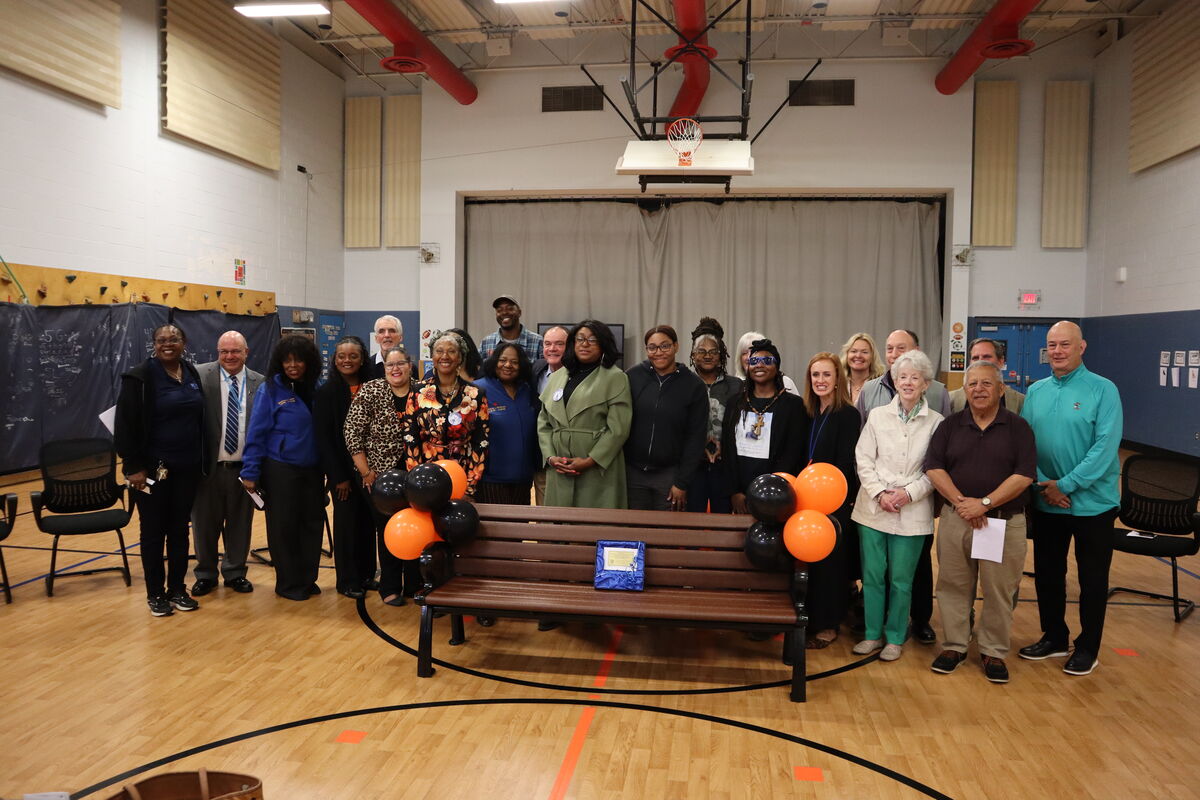 A group photo in front of the newly-dedicated buddy bench