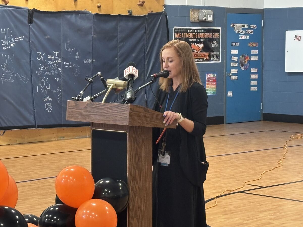Principal Amanda Martinez speaks at the ribbon cutting ceremony for the buddy bench