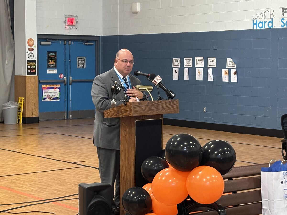 Superintendent of Schools Dr. Joseph Macary speaks at the ribbon cutting ceremony for the buddy bench