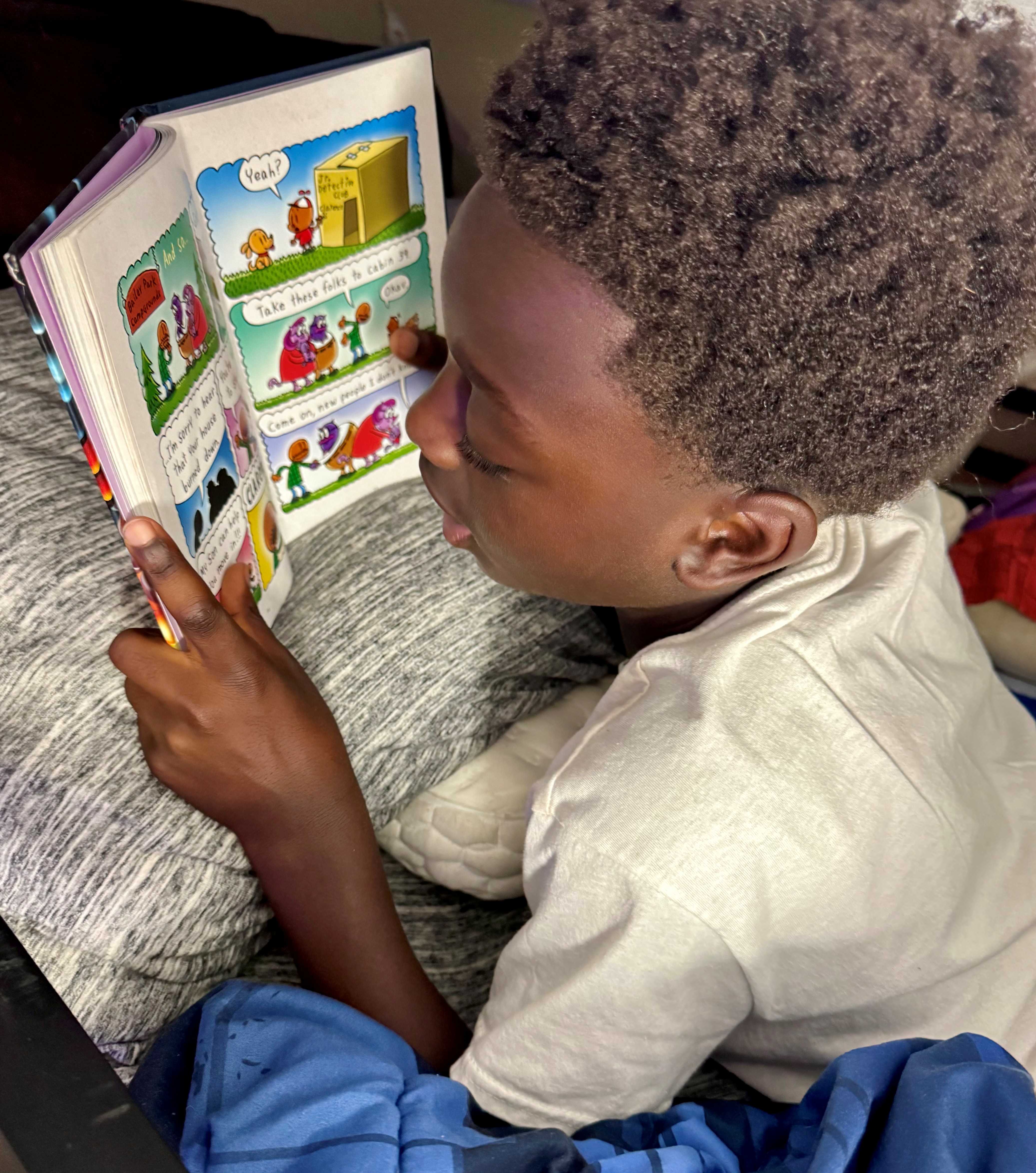 Derrick, a second grader at Chamberlain Elementary School, reads at home.
