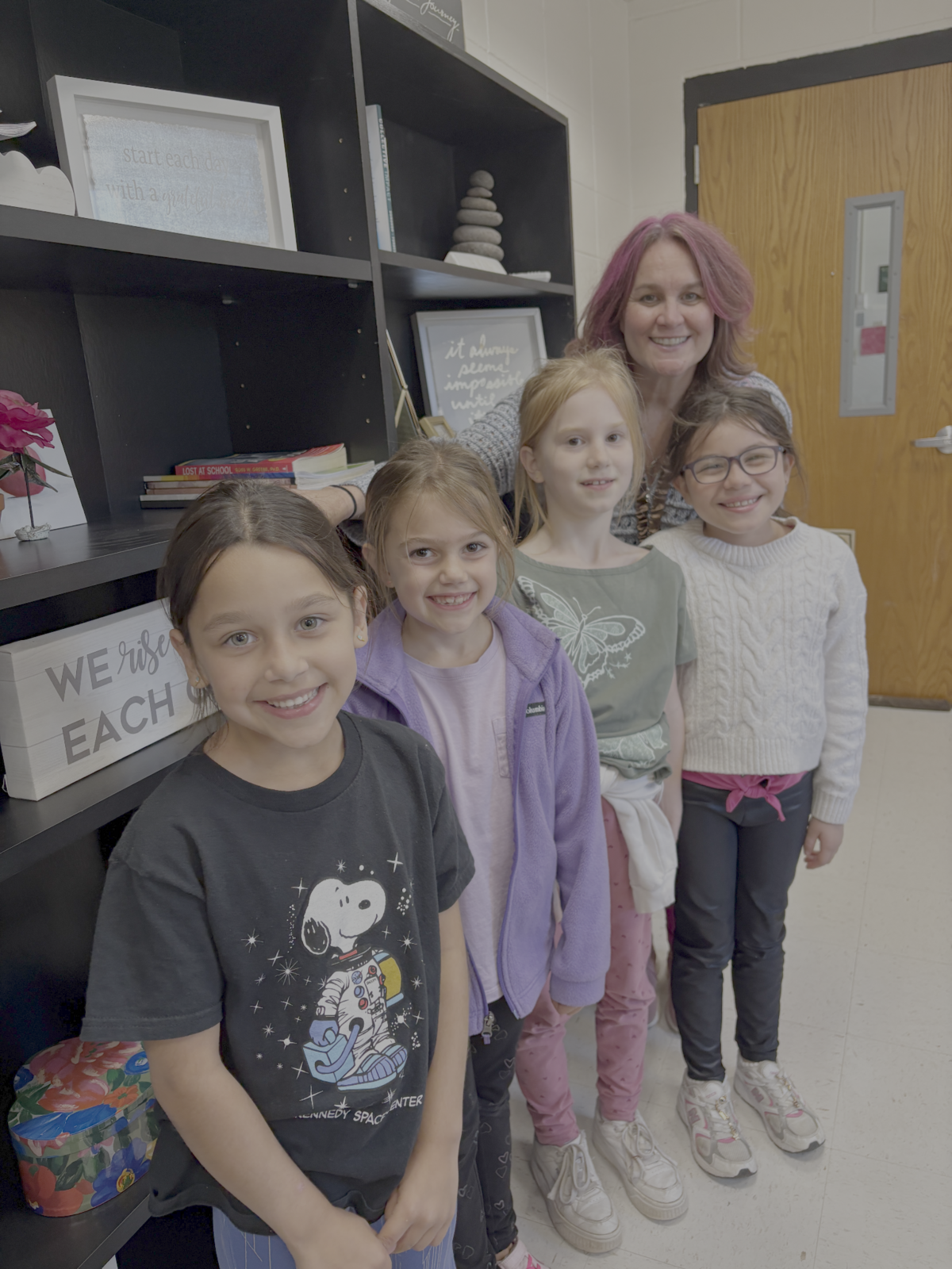 Mrs. Ances standing with a group of students after their VIP Lunch