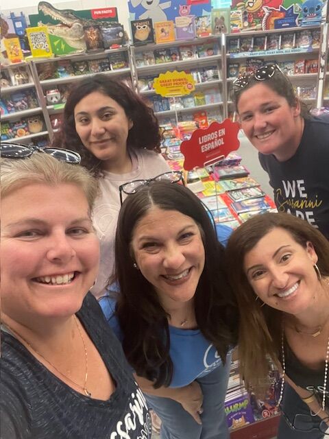 SVUSD staff members smiling together in a school library