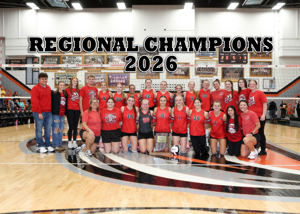 A high school volleyball team poses proudly on a gym court with a trophy, celebrating their regional championship in 2026.