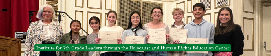 A group of students and an adult pose for a photo, holding certificates.