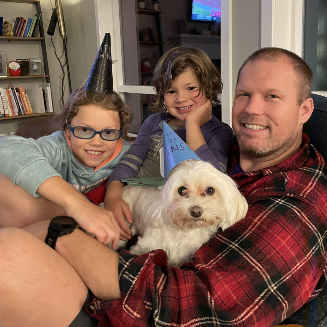 Eric Holzer with children and dog
